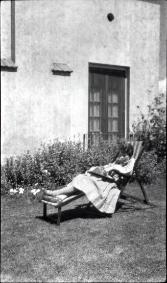 A woman reclining outdoors for TB treatment.